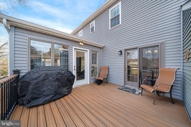 wooden terrace featuring a grill