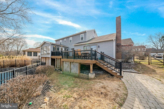 back of property with stairs, fence, a chimney, and a wooden deck