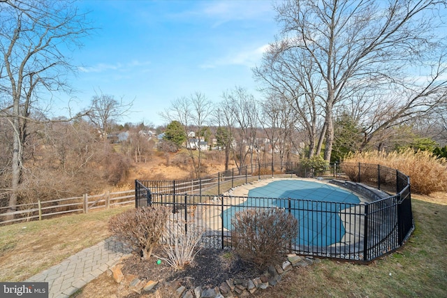 view of swimming pool with a fenced in pool and fence