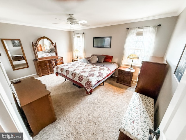 carpeted bedroom with crown molding and ceiling fan