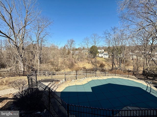 exterior space featuring a fenced in pool and fence