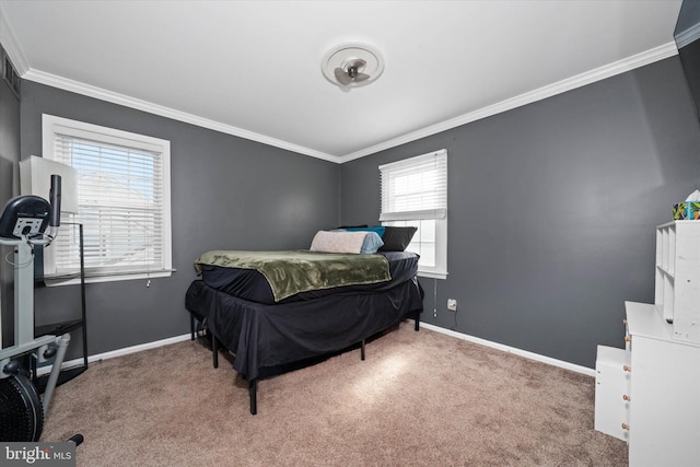 carpeted bedroom featuring crown molding and baseboards