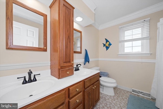 bathroom featuring visible vents, toilet, crown molding, and a sink