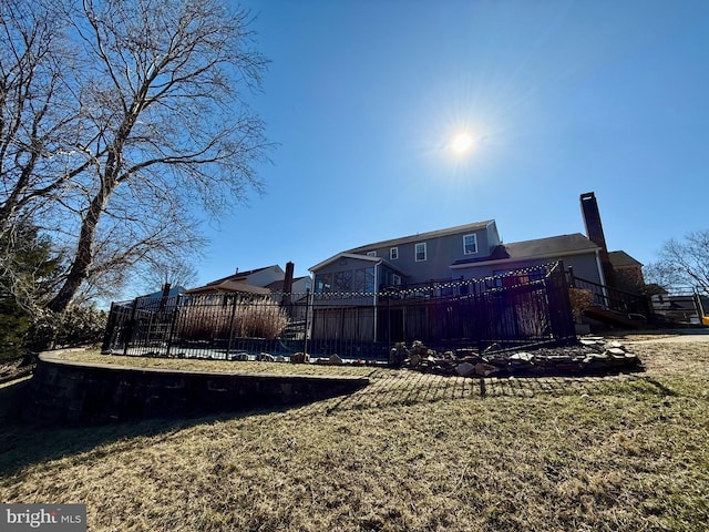 back of property with a yard and a chimney