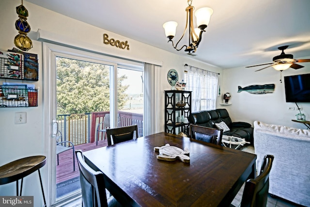 dining area featuring ceiling fan with notable chandelier