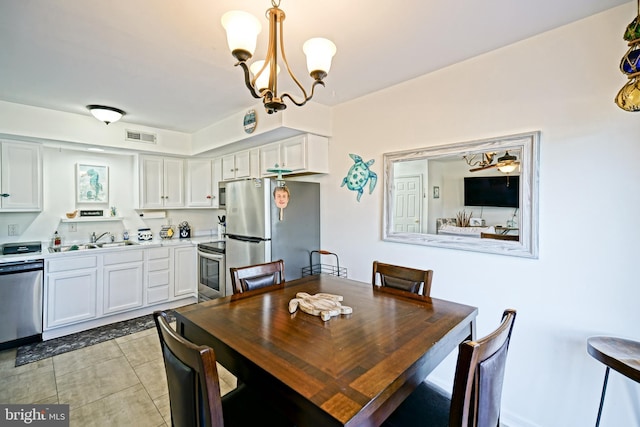 dining area with light tile patterned floors, visible vents, and a notable chandelier