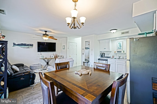 dining area with visible vents and ceiling fan with notable chandelier