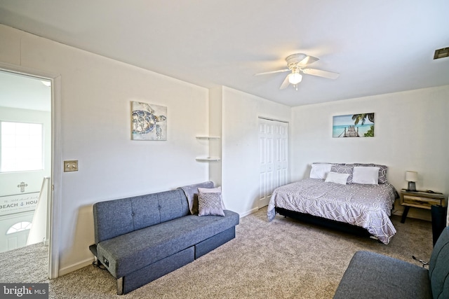 carpeted bedroom featuring visible vents, a ceiling fan, and a closet