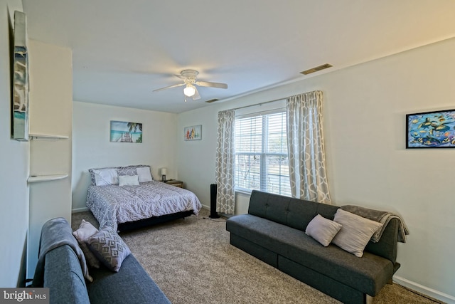 carpeted bedroom with visible vents, baseboards, and ceiling fan