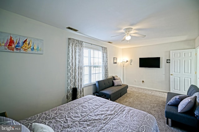 carpeted bedroom with visible vents, baseboards, and ceiling fan