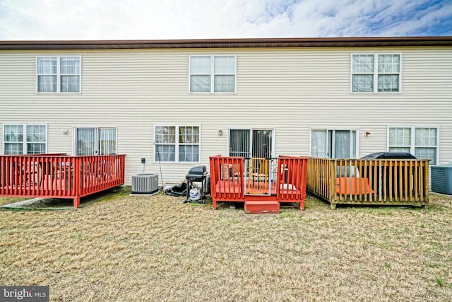 back of house featuring a wooden deck, central AC, and a yard