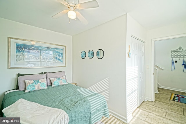 bedroom with a ceiling fan and baseboards