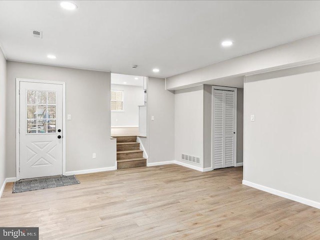 foyer entrance featuring recessed lighting, visible vents, light wood finished floors, and baseboards