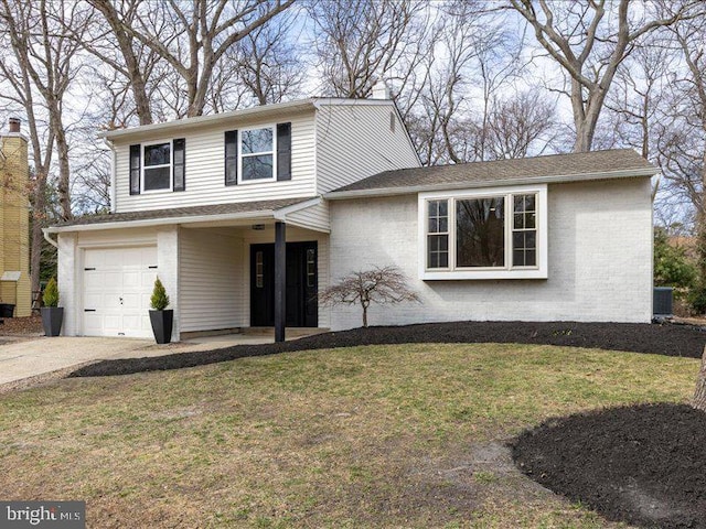 view of front of house with brick siding, a garage, a front lawn, and driveway