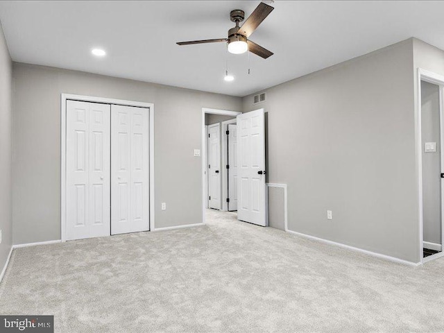 unfurnished bedroom with visible vents, baseboards, a closet, and carpet flooring