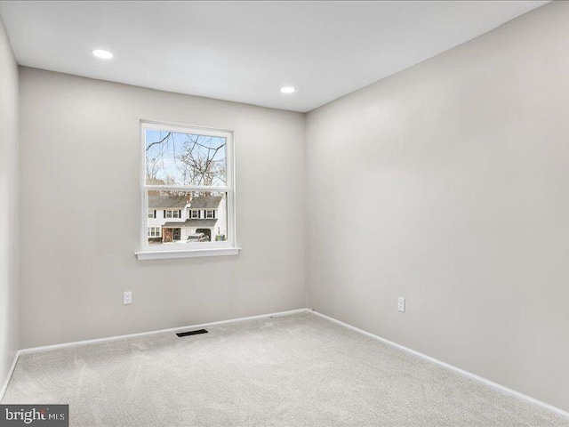 carpeted empty room with visible vents, recessed lighting, and baseboards