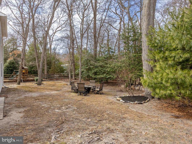 view of yard featuring a playground and fence