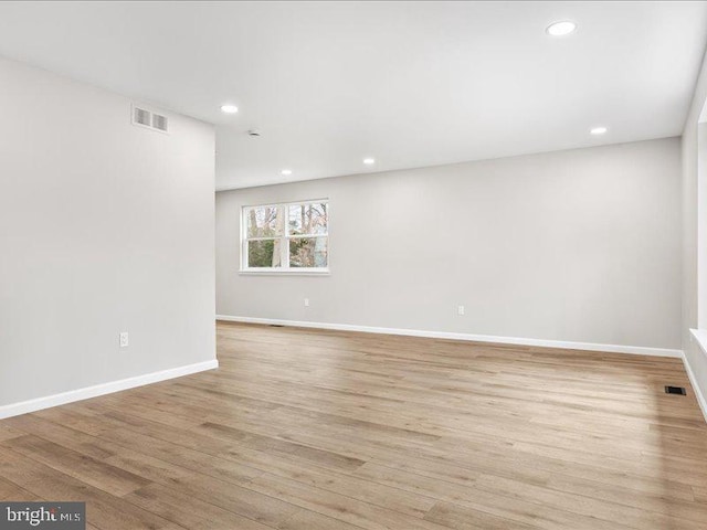 empty room with recessed lighting, baseboards, visible vents, and light wood-type flooring