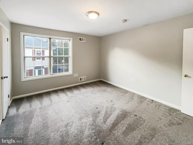 carpeted empty room with baseboards and visible vents