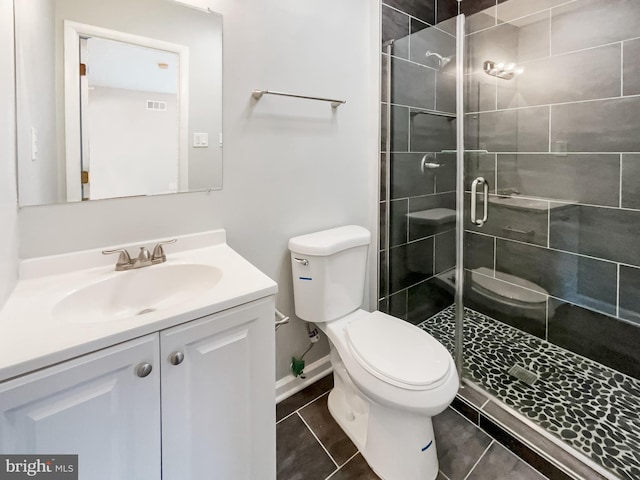 full bath featuring vanity, visible vents, a shower stall, tile patterned floors, and toilet