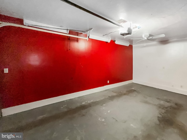 garage featuring baseboards and a garage door opener