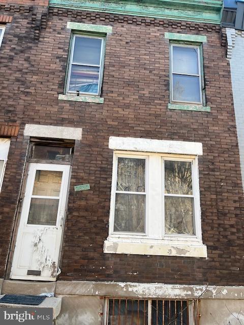 view of side of property with brick siding