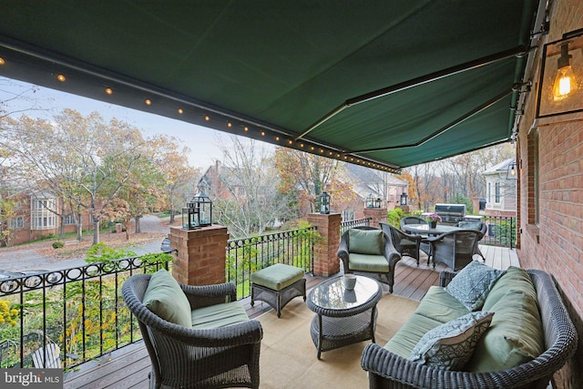 wooden terrace with an outdoor living space