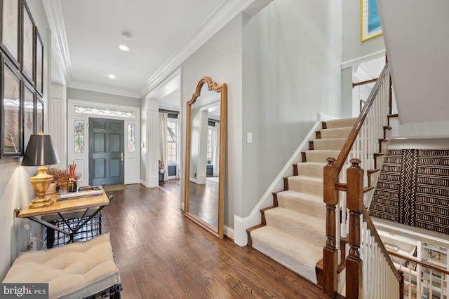 foyer entrance featuring baseboards, stairway, ornamental molding, recessed lighting, and wood finished floors