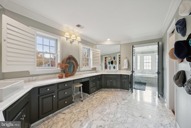 bathroom featuring a wealth of natural light, ornamental molding, a bath, and double vanity