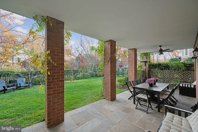 view of patio with outdoor dining space, a fenced backyard, and a ceiling fan