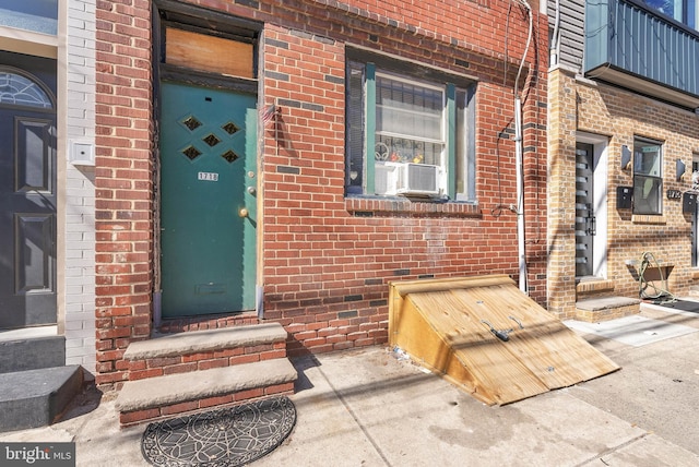 view of exterior entry with brick siding