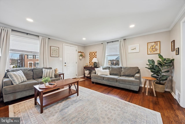 living room with plenty of natural light, crown molding, and dark wood-type flooring