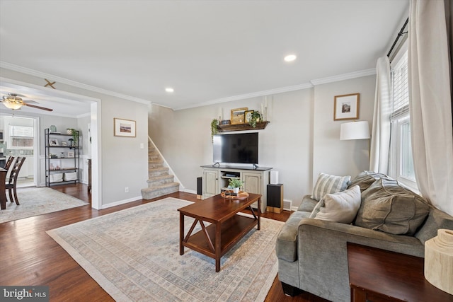 living room with a wealth of natural light, stairway, dark wood finished floors, and baseboards