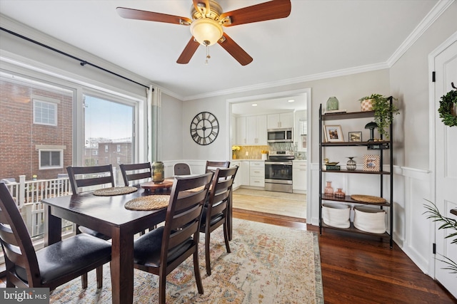 dining room featuring light wood-style floors and ornamental molding