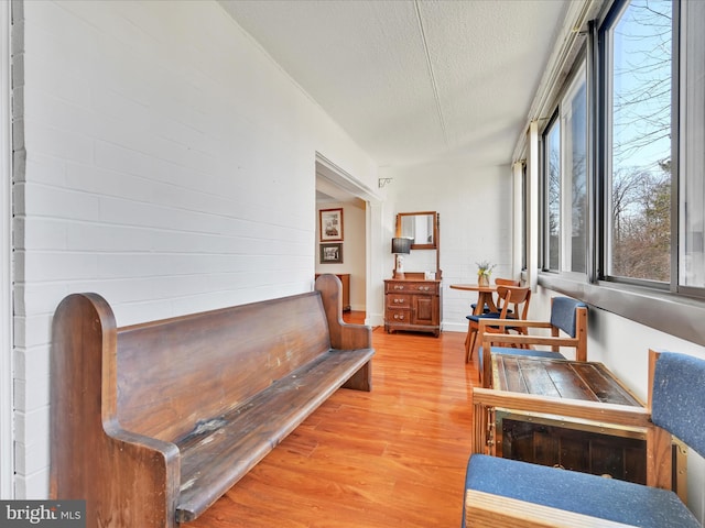 living area with light wood finished floors and a textured ceiling