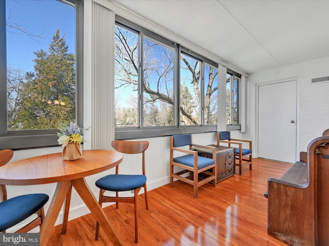 sunroom / solarium with visible vents and a healthy amount of sunlight