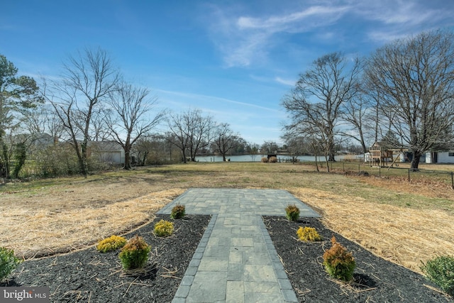 view of yard with fence and a water view