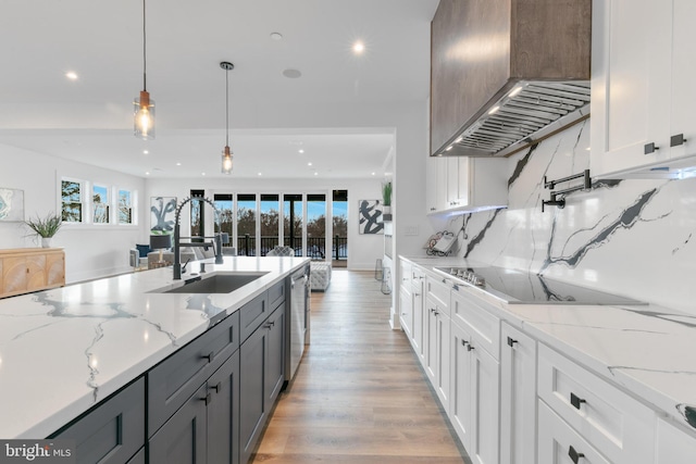 kitchen featuring a sink, tasteful backsplash, stainless steel dishwasher, wall chimney exhaust hood, and black electric cooktop