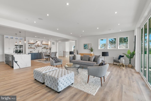 living area featuring recessed lighting and light wood-style flooring