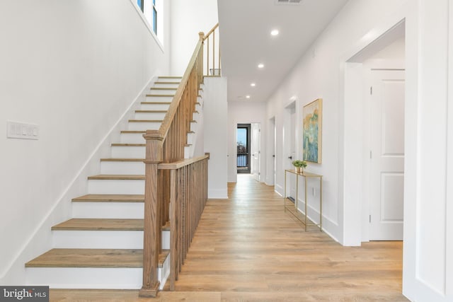 foyer featuring recessed lighting, stairway, visible vents, and wood finished floors