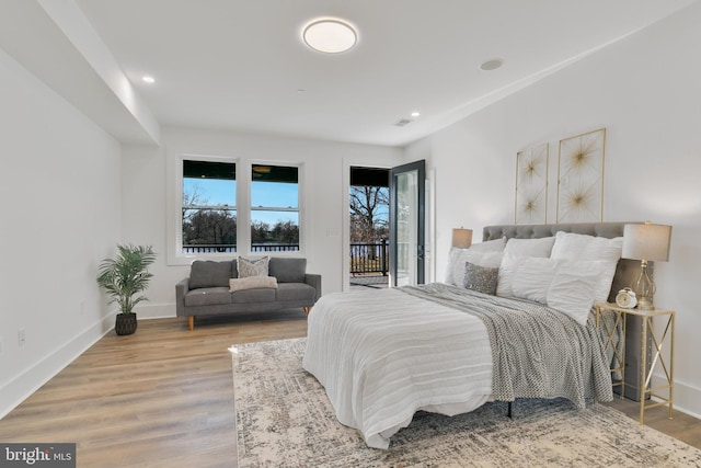 bedroom featuring recessed lighting, wood finished floors, baseboards, and access to outside