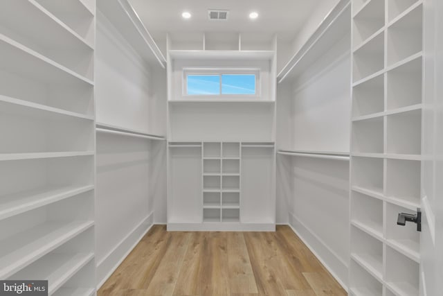 walk in closet featuring visible vents and wood finished floors