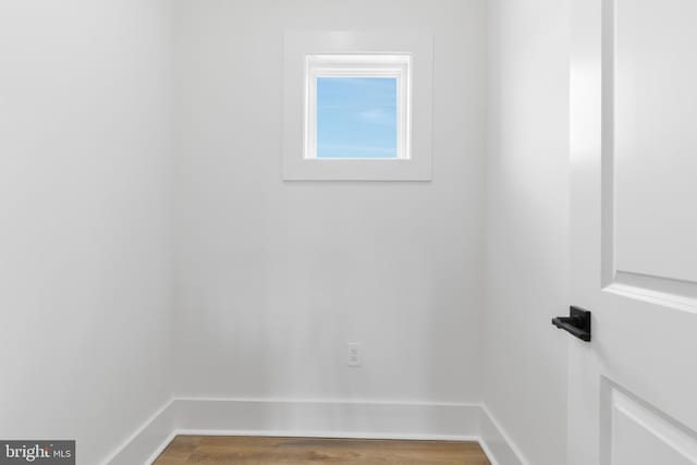 interior space featuring wood finished floors and baseboards