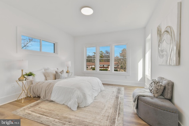 bedroom featuring light wood-type flooring and baseboards