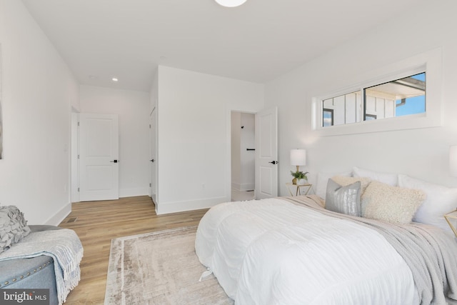 bedroom with baseboards and light wood-style floors