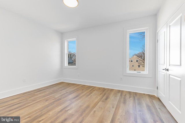 unfurnished bedroom featuring light wood-style flooring and baseboards