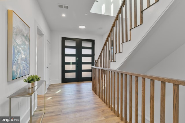 entryway featuring visible vents, stairs, recessed lighting, french doors, and light wood-style floors