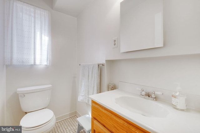 bathroom featuring tile patterned floors, toilet, vanity, and baseboards