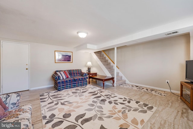 living room featuring visible vents, stairway, and baseboards