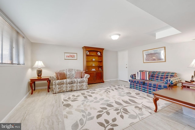 living area featuring baseboards